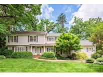 Charming two-story home with a well-maintained lawn and beautiful landscaping surrounding the property at 2000 Ferncliff Rd, Charlotte, NC 28211