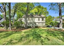 Charming two-story home with a well-maintained lawn and mature trees providing shade at 4738 Truscott Rd, Charlotte, NC 28226