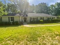 Charming single-story home featuring a well-manicured lawn and inviting curb appeal at 5013 Prestwick Ln, Charlotte, NC 28212