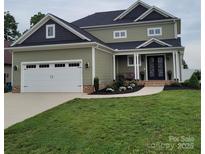 Charming two-story home with a two-car garage, lovely landscaping, and a welcoming front entrance at 5118 Regents Park Dr, Hickory, NC 28602