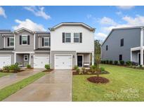 Charming townhome featuring a single-car garage and well-manicured lawn, perfect for suburban living at 518 Tayberry Ln, Fort Mill, SC 29715