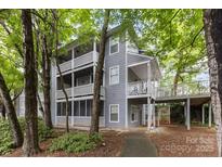 Inviting condo exterior with multiple balconies and lush greenery at 6011 Treetop Ct, Charlotte, NC 28212