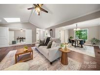 Bright living space with hardwood floors, a comfortable sofa and easy access to the dining area at 7 Turtle Ln, Clover, SC 29710