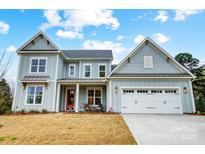 Charming two-story home with a red front door, white garage door, and light blue siding at 110 Adalyn Ivy Ln # 1, Mooresville, NC 28115