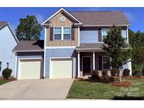 Charming two-story home with a two car garage and manicured lawn at 129 Canada Dr # 85, Statesville, NC 28166