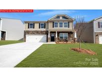 Charming two-story home with stone accents, a well-manicured lawn, and an attached two-car garage at 133 Way Cross Ln, Troutman, NC 28166