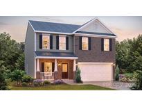 Charming two-story home with a brick facade, covered front porch, and attached two-car garage at 136 Mary Locke Way, Statesville, NC 28677