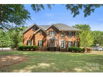 Stately brick home with a lush green lawn and mature landscaping, offering classic curb appeal at 1498 Farrow Dr, Rock Hill, SC 29732