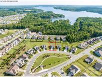 Beautiful aerial view of a Primary-planned community nestled on the lake surrounded by lush green trees at 15429 Topanga Dr, Charlotte, NC 28278