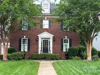 Charming two-story brick home with mature trees and meticulously maintained front yard at 20107 N Cove Rd, Cornelius, NC 28031