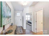 Inviting foyer with wood floors, complemented by a stylish console table and neutral decor at 2636 Tillman St, Monroe, NC 28112