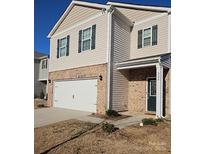 Inviting two-story home featuring a brick facade, attached garage, and well-maintained landscaping at 324 Gaines Rd # 8, Clover, SC 29710