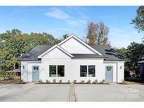 Charming duplex with modern farmhouse appeal, boasting a symmetrical facade and inviting curb appeal at 3314 & 3316 Cedarhurst Dr, Charlotte, NC 28269