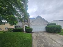 Charming two-story home with a stone-accented facade, attached garage, and well-kept front lawn at 3912 Laurel View Cir, Indian Trail, NC 28079
