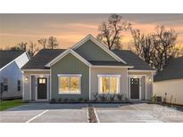 Charming exterior view of the newly built property, featuring neutral siding and modern architectural details at 4815 & 4817 Victoria Dr, Charlotte, NC 28269