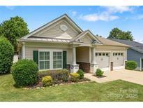 Charming single-story home with a two-car garage, manicured lawn, and tasteful landscaping at 611 Tee Ridge Ct, Fort Mill, SC 29715