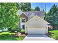 Charming two-story home featuring an attached garage and well-manicured landscaping, flag out front at 7833 Taymouth Ln, Charlotte, NC 28269
