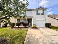 Charming home featuring manicured lawn, lovely shrubs, and a covered front porch at 815 Fescue Ct, Charlotte, NC 28216