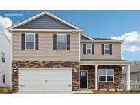 Two-story home featuring stone accents, neutral siding, black shutters, and an attached two-car garage at 820 Candy Dr, Statesville, NC 28677