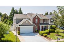 Charming two-story home with red shutters, attached two-car garage, and well-manicured front lawn at 10815 Mountain Springs Dr, Charlotte, NC 28278