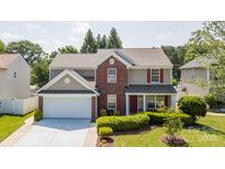 Charming two-story home with red shutters, brick accents, and a well-manicured front lawn at 10815 Mountain Springs Dr, Charlotte, NC 28278