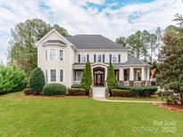 Beautiful two-story home with a well-manicured lawn and charming front porch at 123 Yellow Jacket Cir, Mooresville, NC 28117