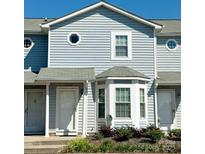 Charming townhome with light blue siding, a bay window, and a well-maintained front yard with mature landscaping at 1430 River Dr # 14, Belmont, NC 28012