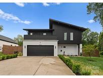 Striking modern home featuring a black and white exterior, clean lines, and well-manicured landscaping at 2913 Lake Ave, Charlotte, NC 28208