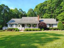 Charming home with a welcoming front porch and well-manicured lawn at 322 Killian Rd, Stanley, NC 28164