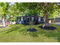 Charming blue house with inviting front porch and lush green lawn at 3637 Glenville Rd, Charlotte, NC 28215