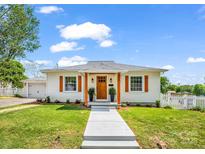 Charming single-story home features a well-manicured lawn, updated shutters, and a welcoming front porch at 411 W Sycamore St, Lincolnton, NC 28092