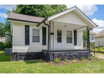 Charming single-story home featuring a cozy front porch and well-maintained landscaping at 520 E Maple Ave, Gastonia, NC 28054