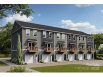 New townhome construction features individual garages, balconies, and neutral color palette at 528 Beatties Ford Rd, Charlotte, NC 28216