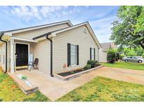 Charming single-story home with light beige siding, black shutters, and well-maintained front yard at 5804 Fairchase Ave, Charlotte, NC 28269