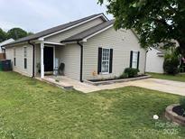 Charming single story home with neutral siding, black shutters, and a well-manicured lawn at 5804 Fairchase Ave, Charlotte, NC 28269