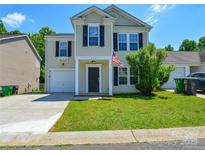 Charming two-story home with a well-manicured lawn and attached garage and crisp contrasting shutters at 7311 Fig Ln, Charlotte, NC 28215