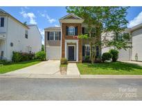 Charming two-story home featuring a brick facade, attached garage, and well-maintained lawn at 7711 Brisbane Ct, Charlotte, NC 28215