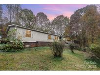 Charming single-story home surrounded by trees; features neutral siding and a cozy, inviting facade at 811 Acclaim Dr, York, SC 29745