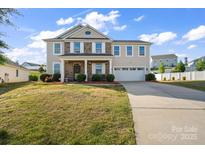 Charming two-story home with a brick facade, landscaped yard, and an attached two-car garage at 9533 Silverdale Ln, Charlotte, NC 28269