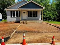 Charming single-story home featuring black shutters, gray siding, and a freshly prepped front yard at 1024 Short St, Salisbury, NC 28144