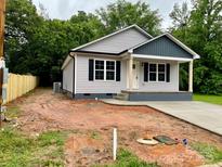Charming single-story home with gray siding, black shutters, and a welcoming front porch at 1024 Short St, Salisbury, NC 28144
