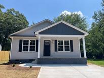 Charming single-story home with gray siding, black shutters, and a welcoming front porch at 1024 Short St, Salisbury, NC 28144