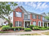 Charming brick-front townhome with a well-manicured lawn and inviting entrance at 10378 Alexander Martin Ave, Charlotte, NC 28277
