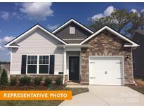 Charming single-Gathering home featuring stone accents, a one-car garage, and a well-manicured lawn at 1260 Langston Ln, Salisbury, NC 28144