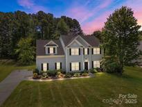 Charming two-story home with beautiful landscaping and classic architectural details at 148 Spring Grove Dr, Mooresville, NC 28117