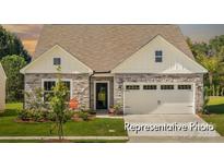 Charming single-Gathering home with stone accents, a two-car garage, and a well-manicured lawn at 1509 Autumn Banks Way # 4P, High Shoals, NC 28077