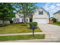 Charming two-story home with a well-maintained lawn, white garage door, and blue shutters at 170 Heywatchis Dr, Mooresville, NC 28115