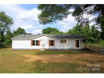 Charming single-story home with white siding, red shutters, and well-maintained front yard at 2002 Kingston Rd, Kingstown, NC 28150