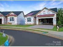 Street view of new construction homes with Tyvek wrap in a suburban neighborhood at 2085 Bonds Ln # 26, Fort Mill, SC 29715