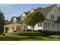 Charming white home with a manicured lawn and classic architectural details at 21121 Shearer Rd, Davidson, NC 28036